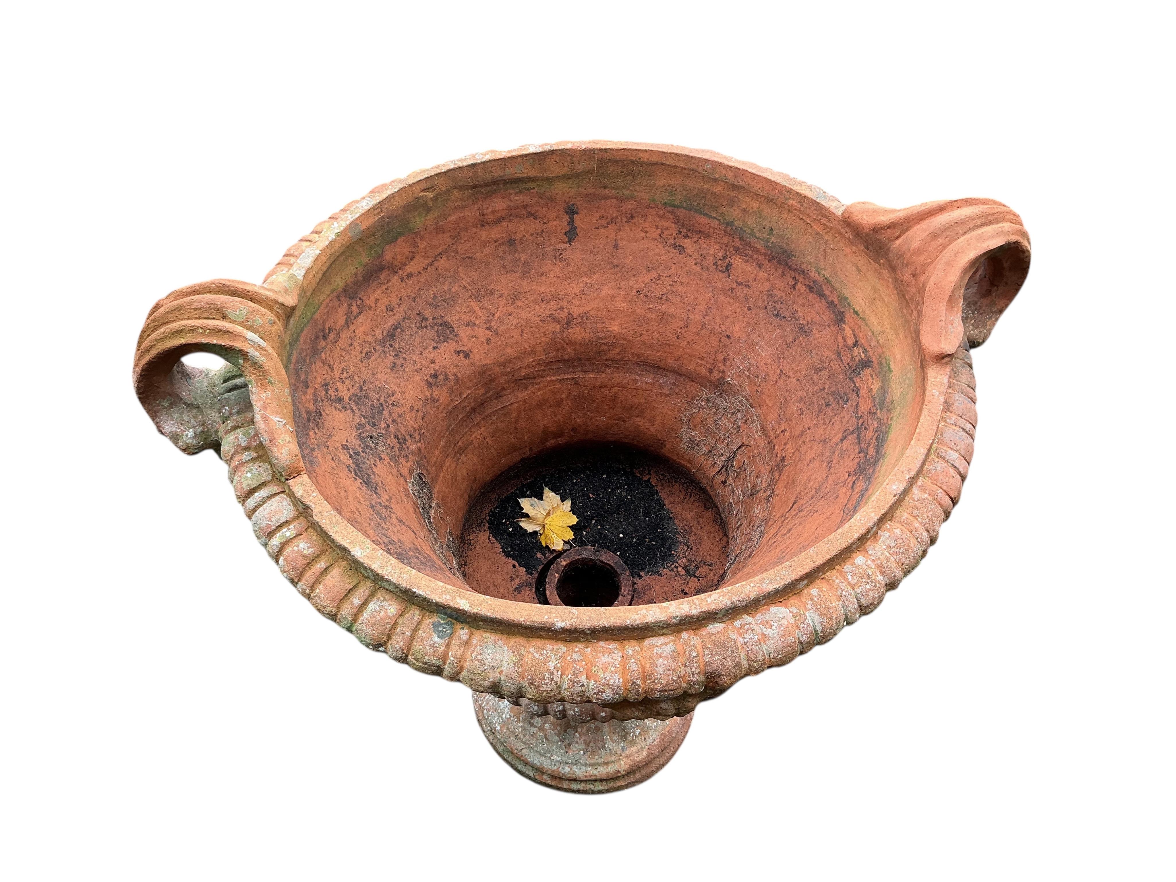 A large circular terracotta planter, diameter 72cm, height 86cm